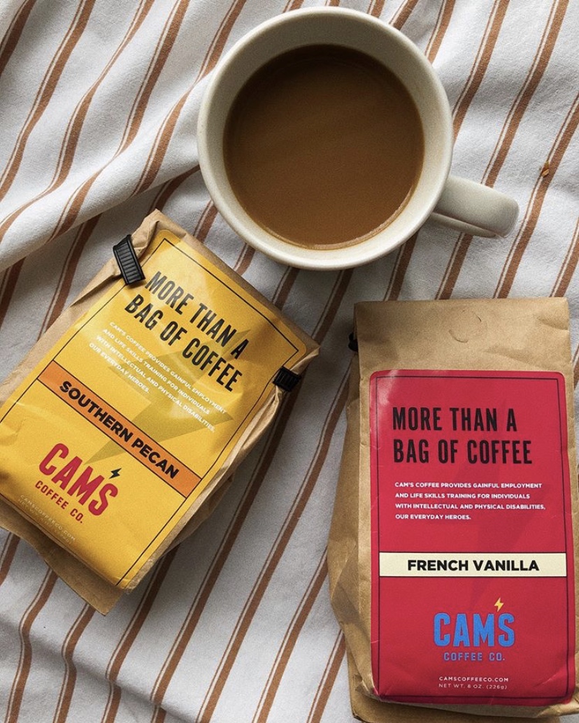 Cam's Coffee bags and a freshly brewed cup of coffee